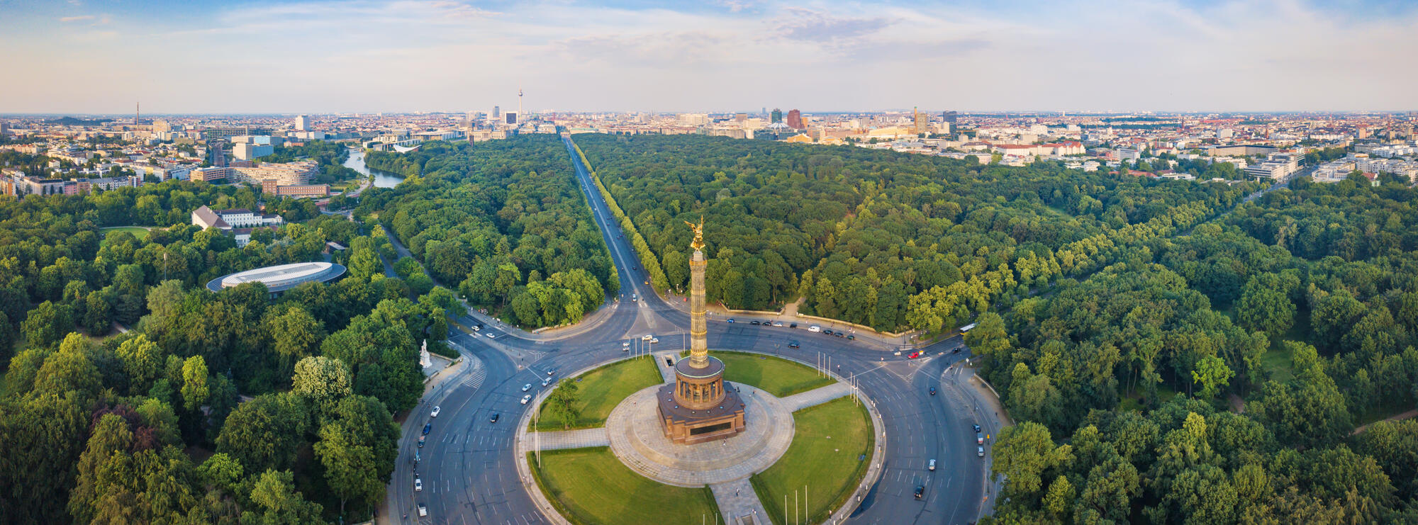 The Victory Column at Großer Stern among the trees of Tiergarten, with central Berlin beyond.