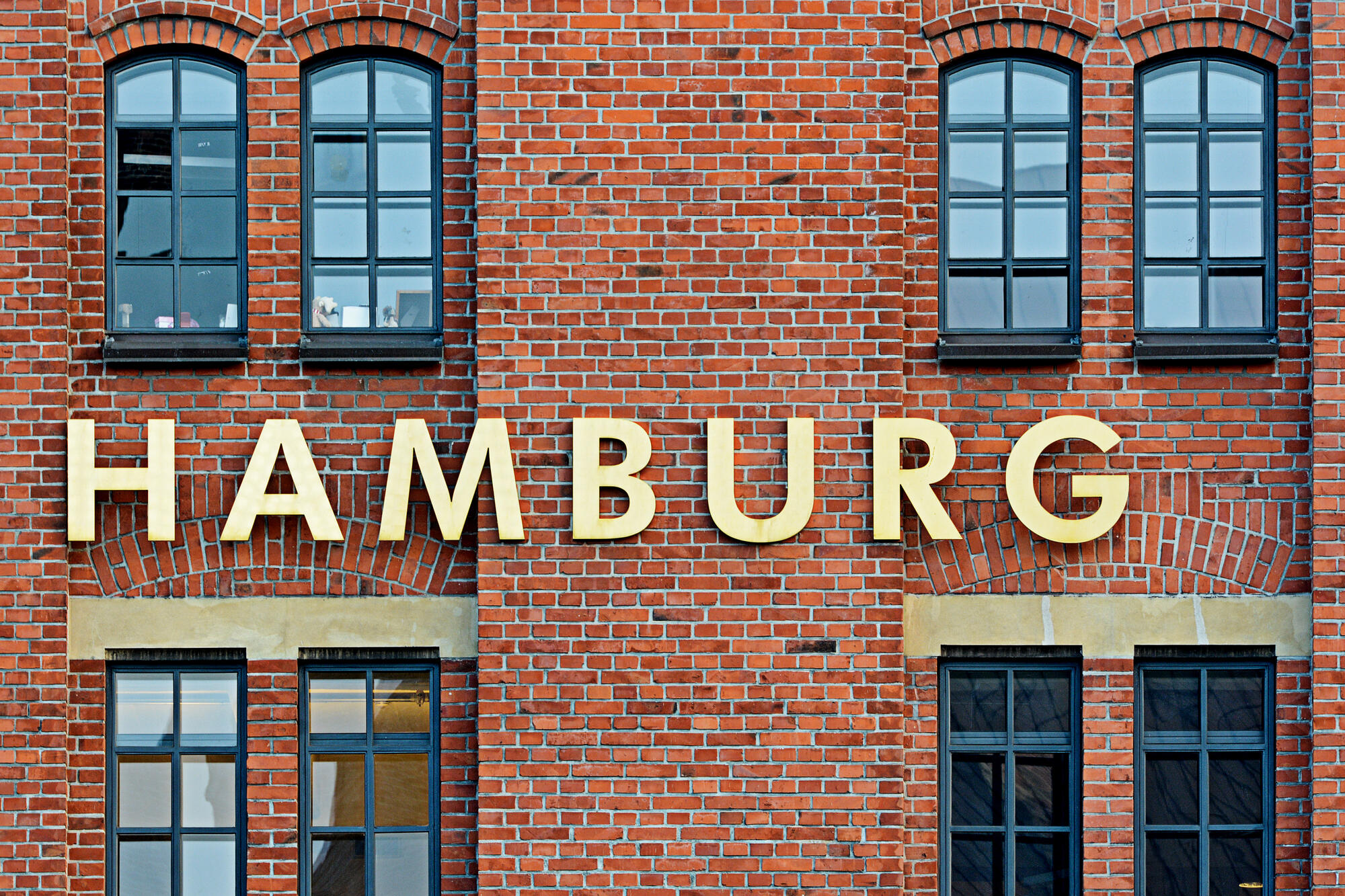 Hamburg lettering on a brick façade.