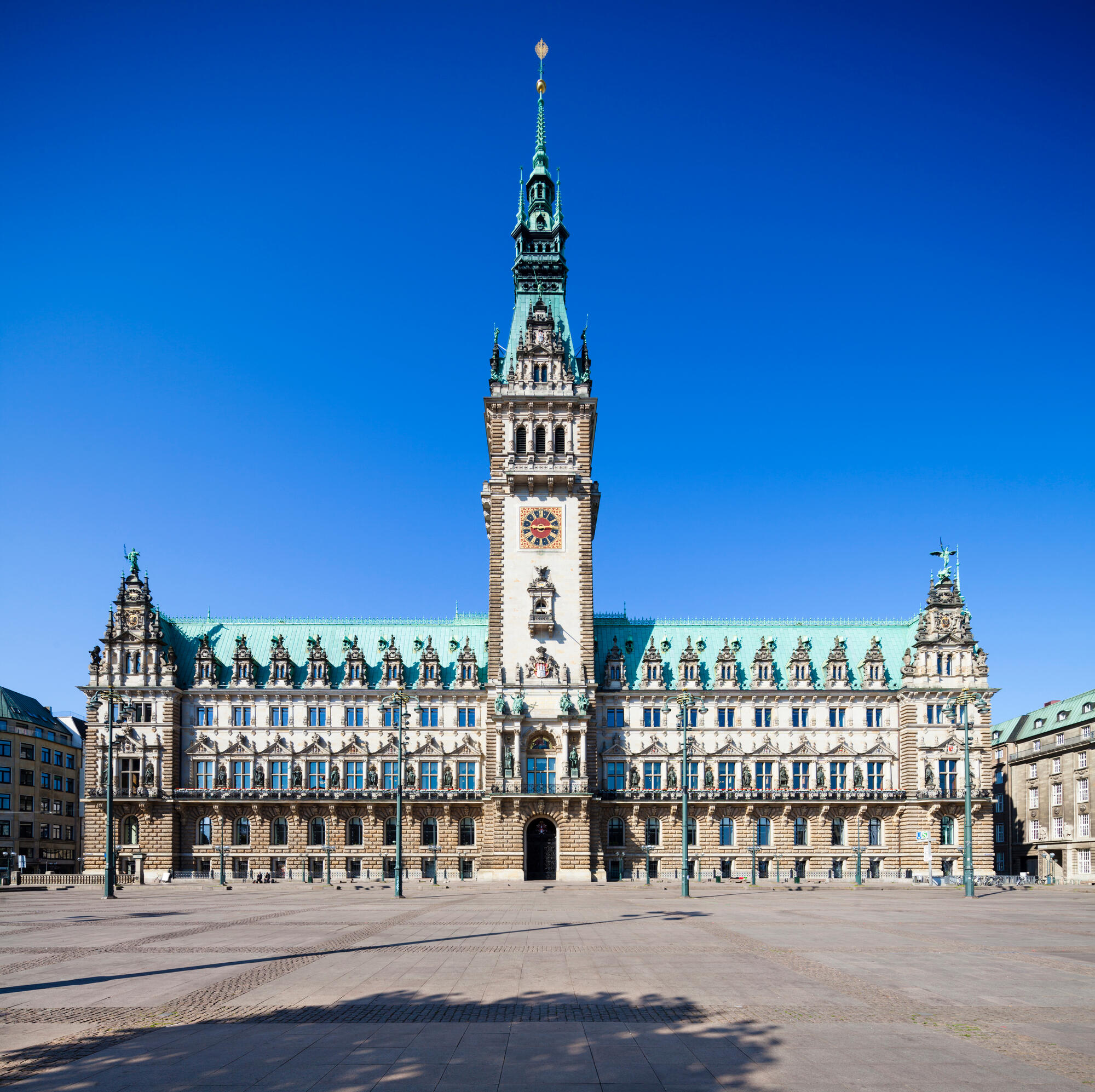 Hamburg Town Hall beneath a blue sky.