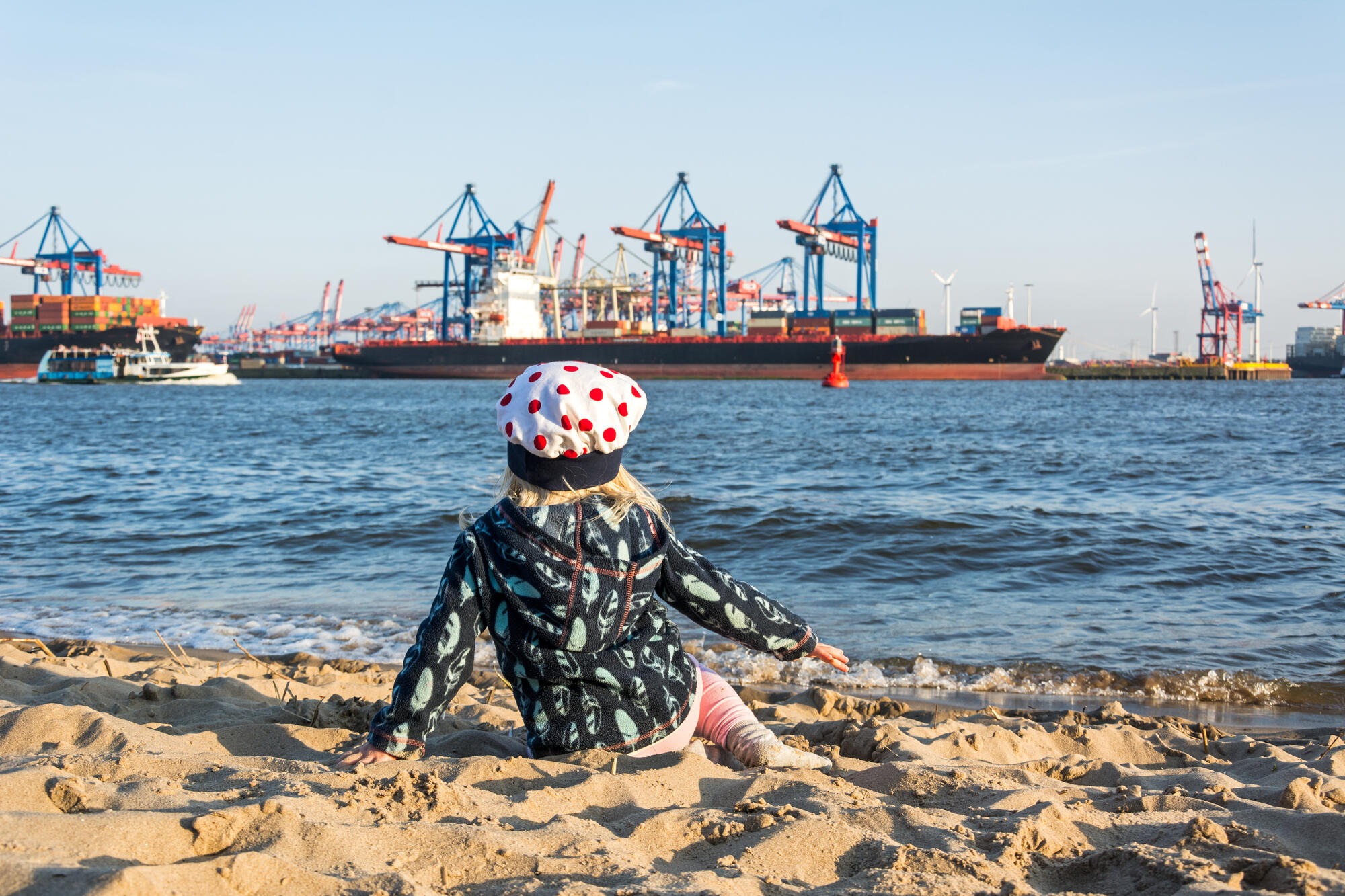 A child wearing a sun hat on an Elbe beach.