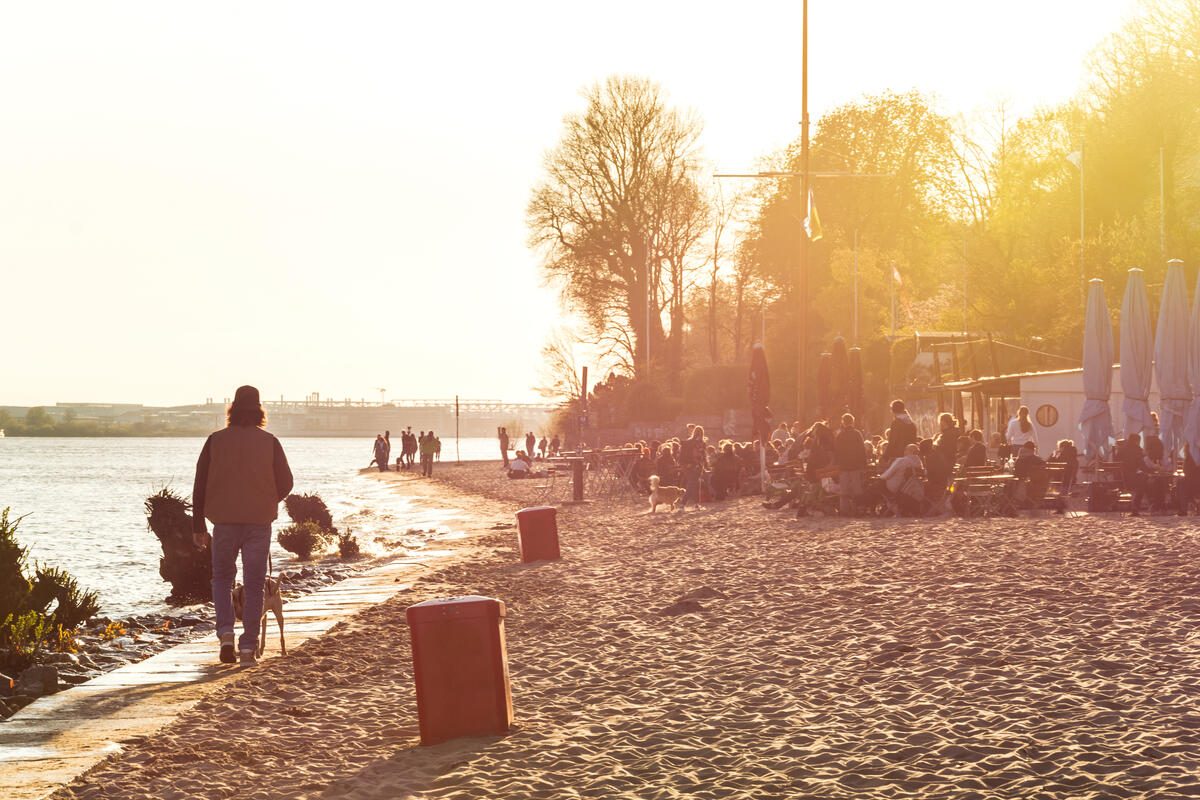 People on an Elbe beach in evening light.