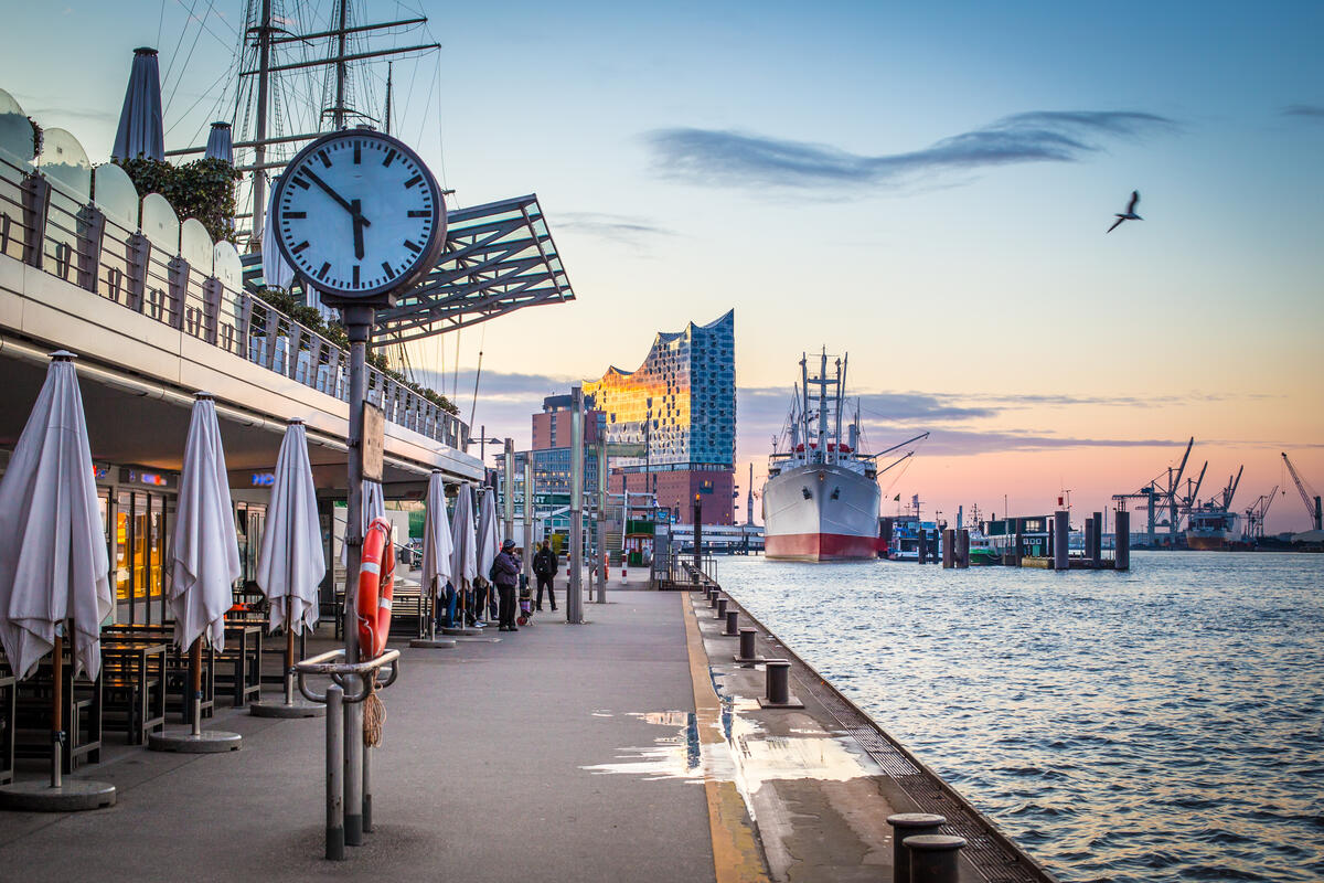A clock and waterfront promenade in Hamburg’s harbour.