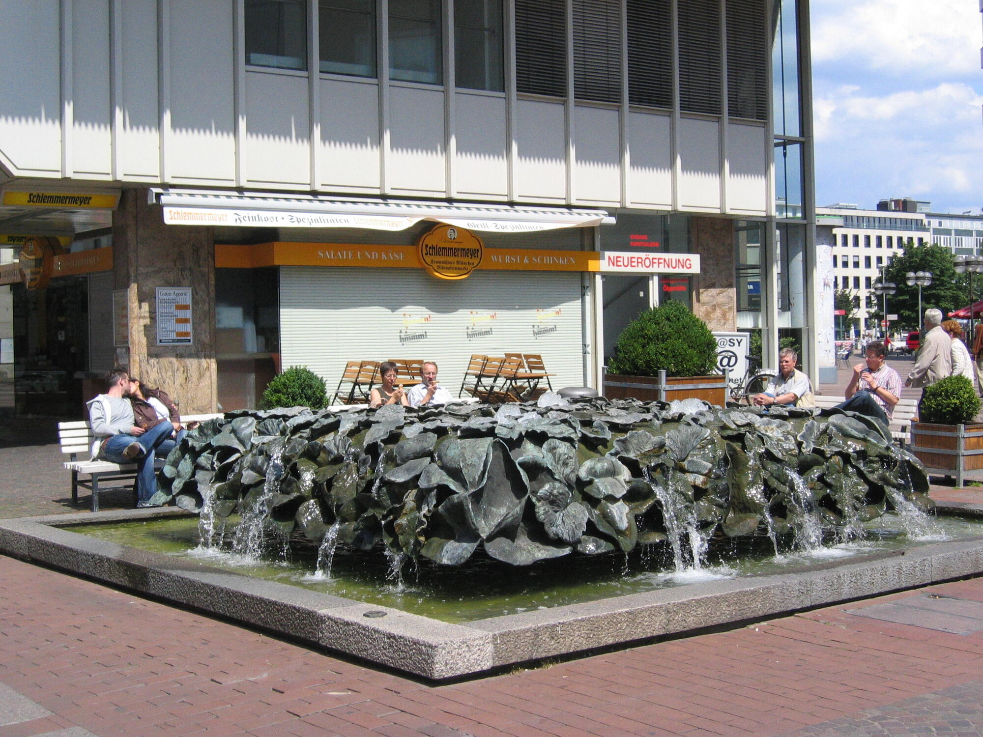 Fountain with water feature and benches in the city centre