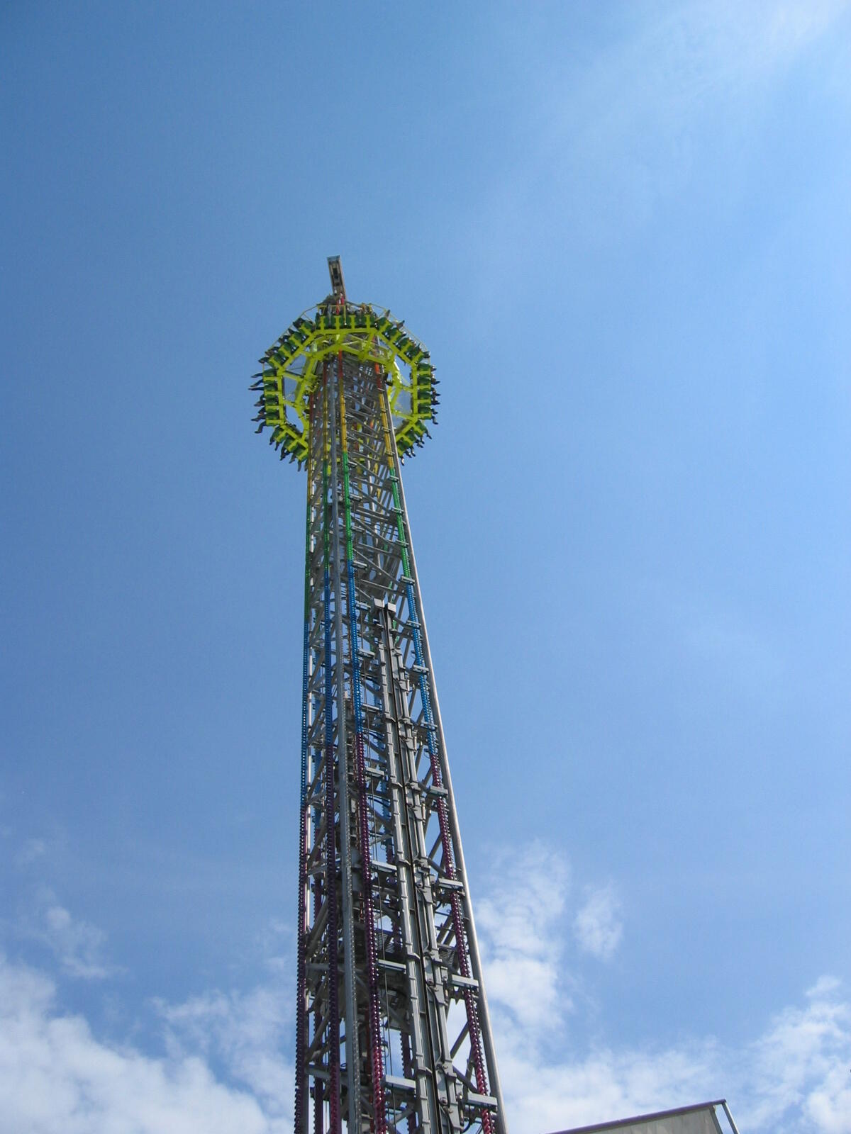 Tall drop tower against a blue sky