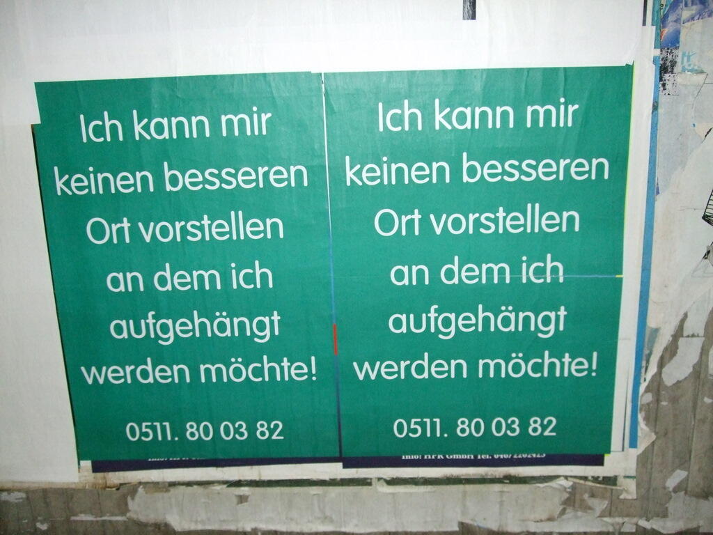 Two green signs bearing the words: I can’t think of a better place to be hung