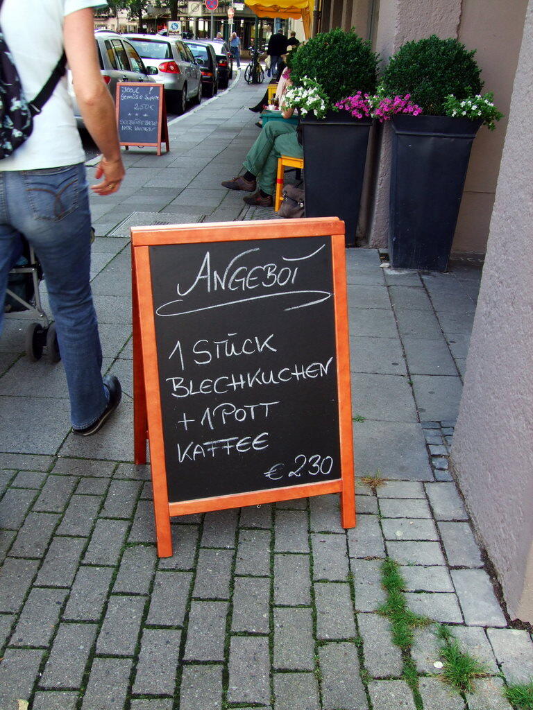Chalkboard outside a café: 1 slice of traybake + 1 mug of coffee, €2.30
