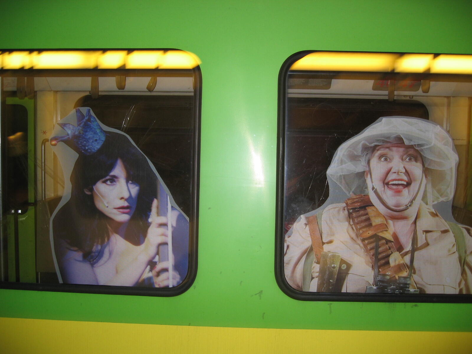 Green light rail carriage with window advertising
