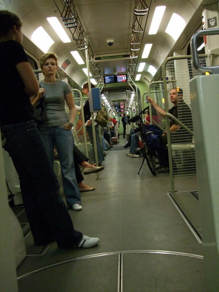 Standing and seated passengers in a light rail carriage