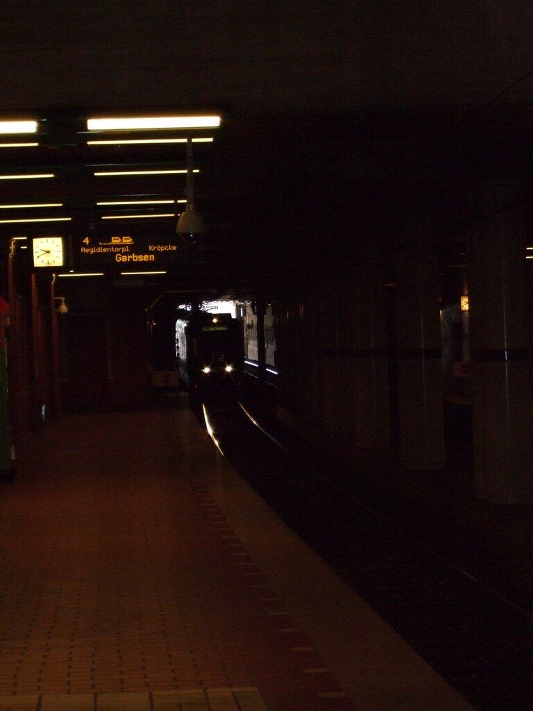 Light rail train enters a dark underground station