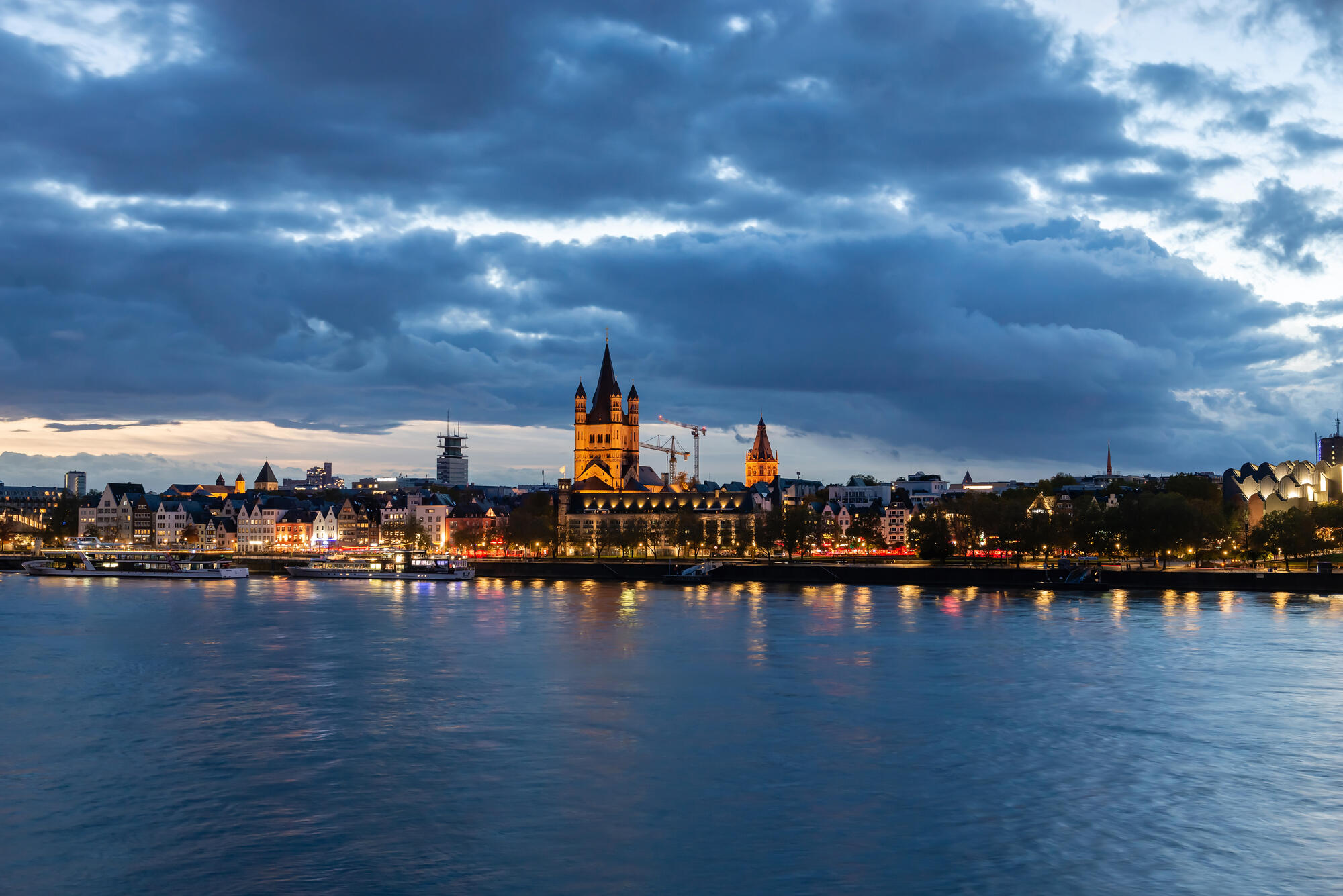 Cologne’s old town beneath a cloudy evening sky.