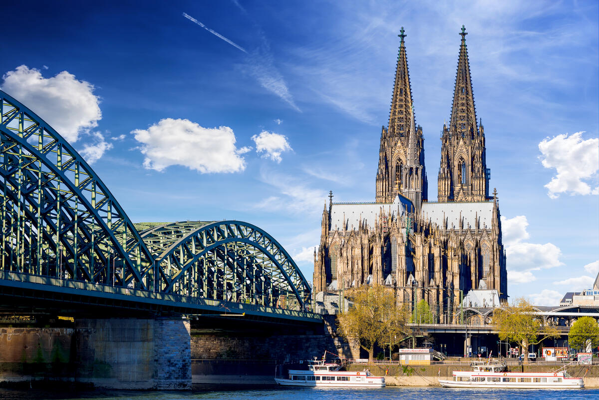 Cologne Cathedral and Hohenzollern Bridge in daylight.
