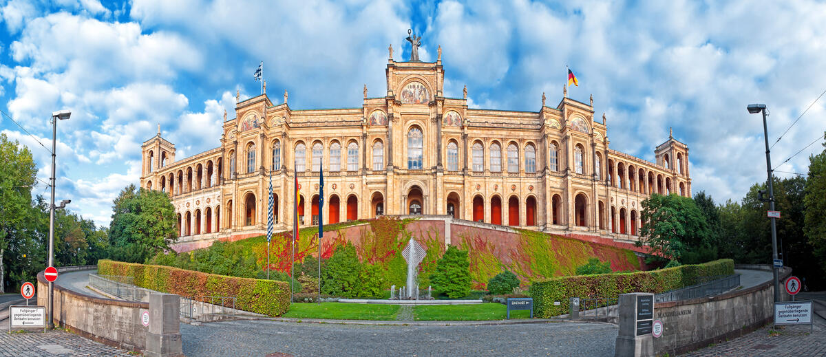 Munich’s Maximilianeum beneath a cloudy sky.