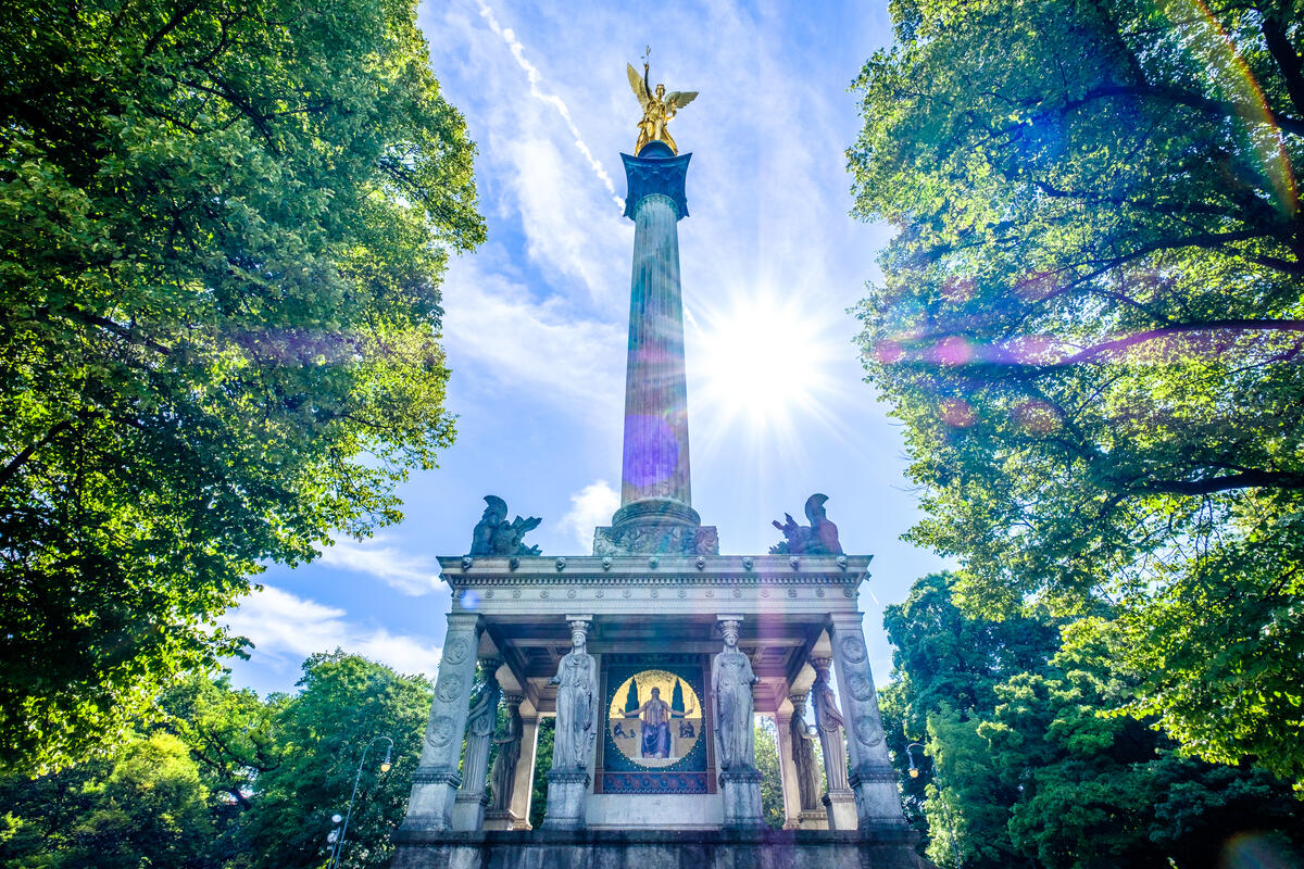 Munich’s Angel of Peace framed by green trees.