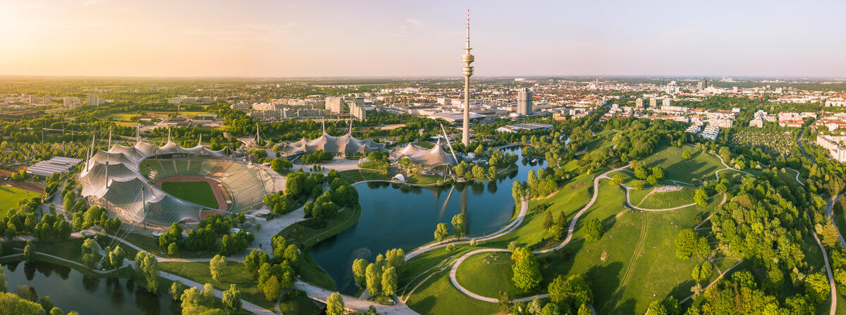 Munich’s green Olympic Park in evening light.