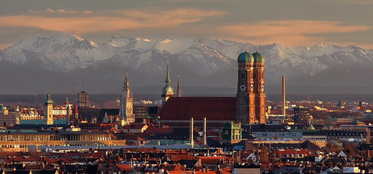 Munich with the snow-covered Alps behind it.