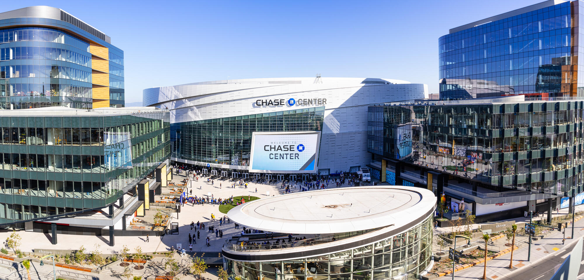 This elevated 2019 view shows the arena, its large outdoor screen, the plaza and the neighbouring glass office buildings.
