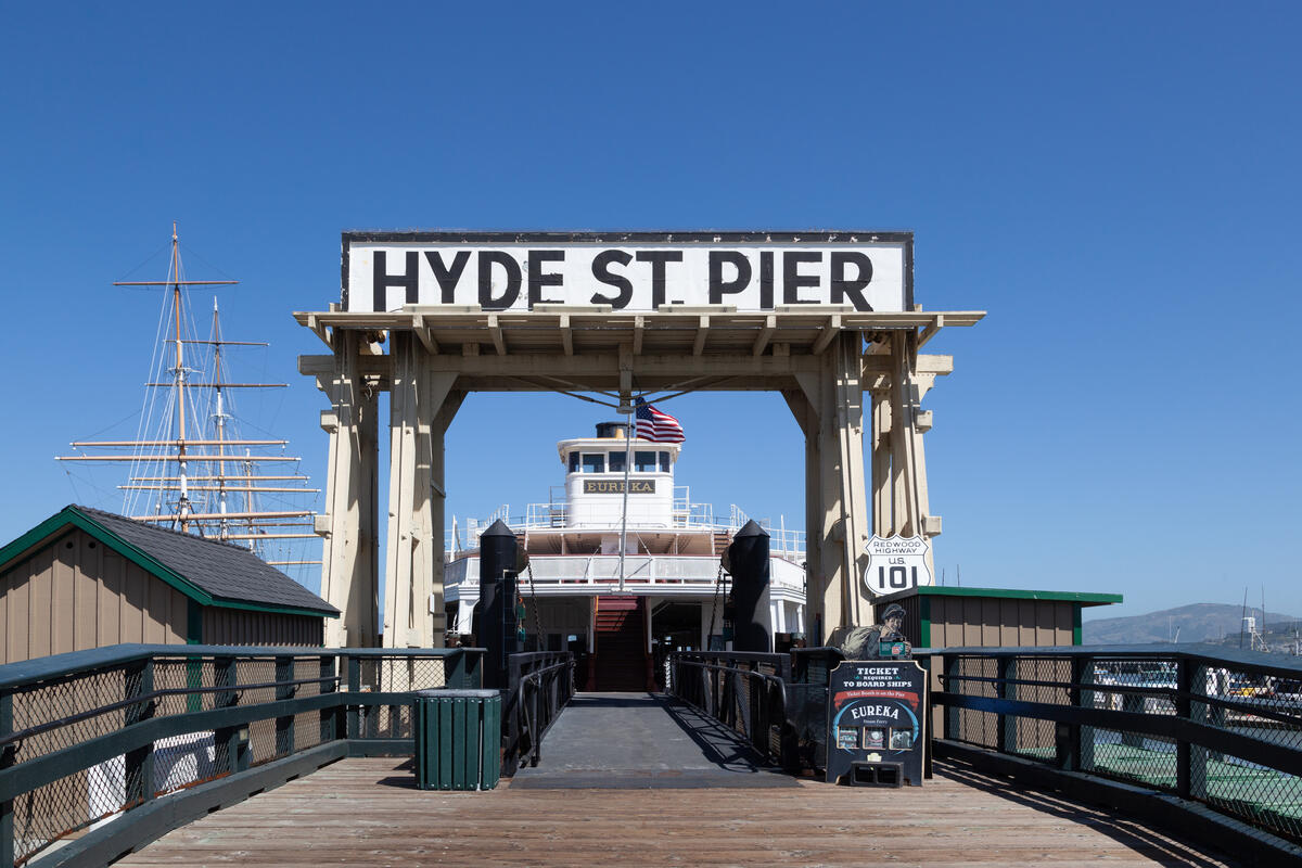 This 2012 image looks through the wooden entrance gate towards the pier and the museum ships beyond.