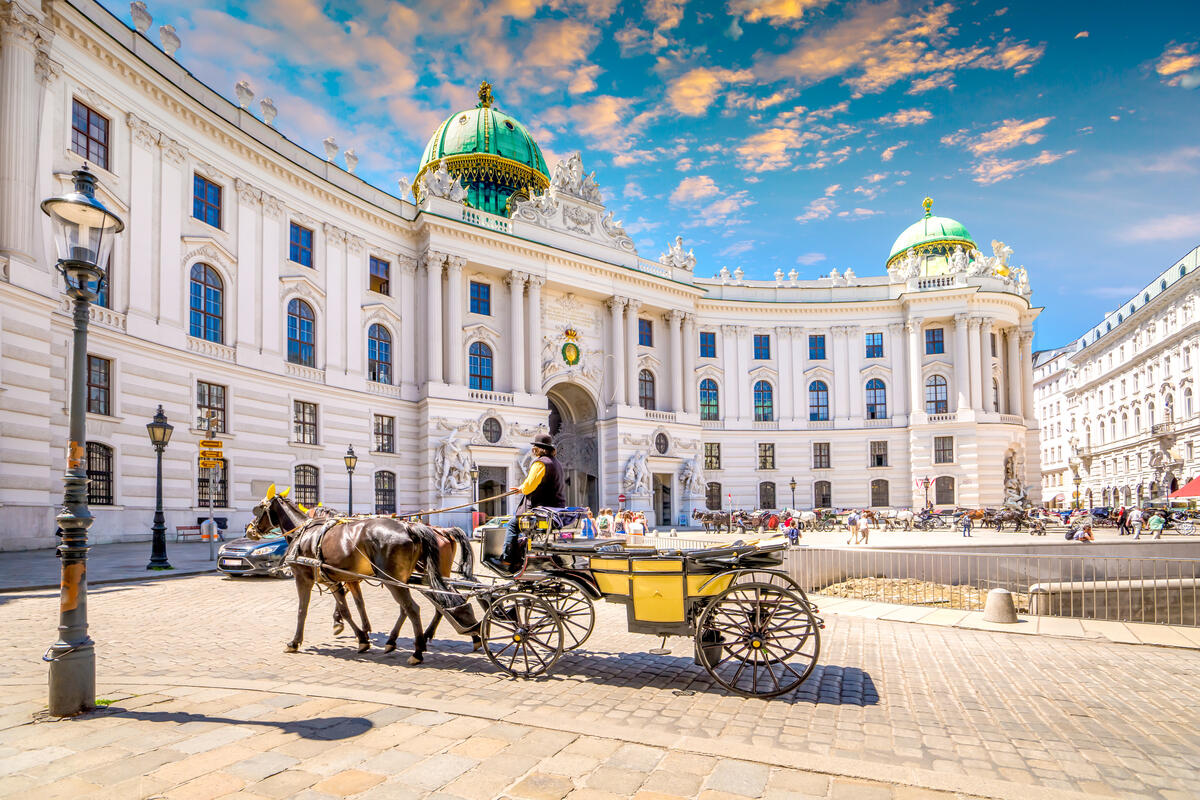 A horse-drawn carriage on Michaelerplatz in front of the Hofburg in Vienna.