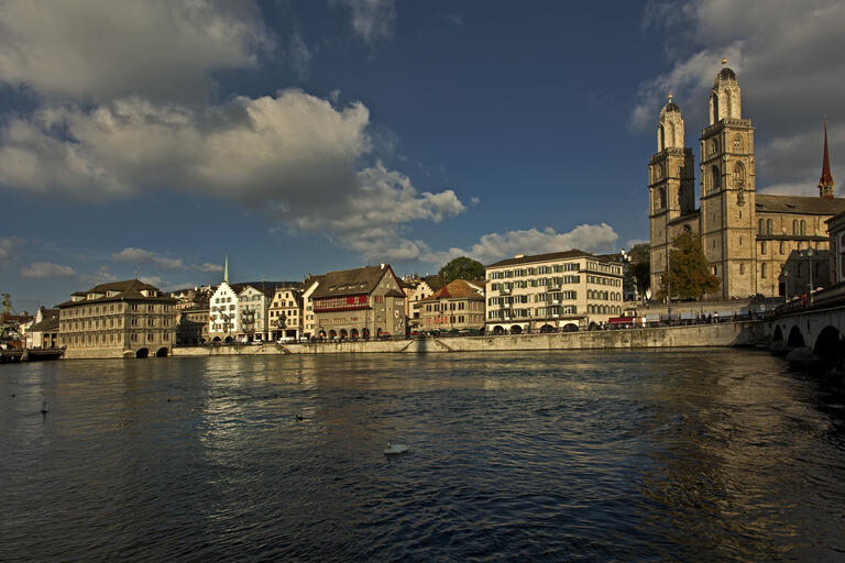 Grossmünster and the buildings along Limmatquai in Zurich, seen from the opposite bank.